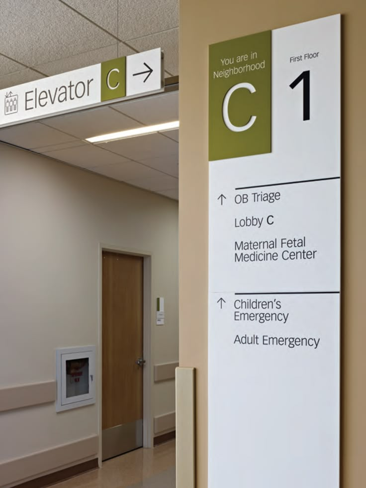 a hospital hallway with signs on the wall