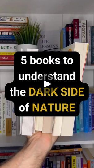 a person holding up a book in front of bookshelves with text reading 5 books to understand the dark side of nature