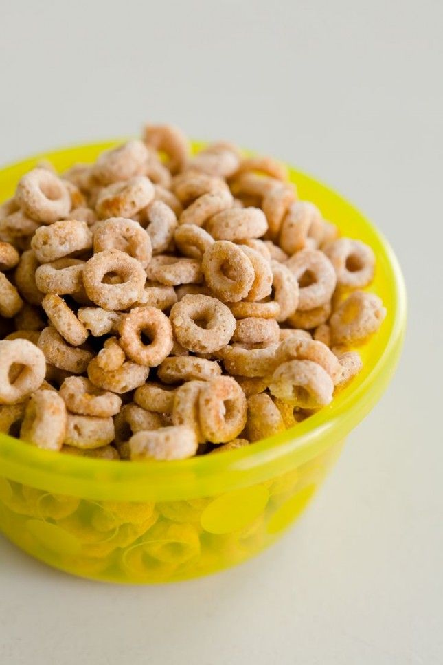 a yellow bowl filled with cereal sitting on top of a table