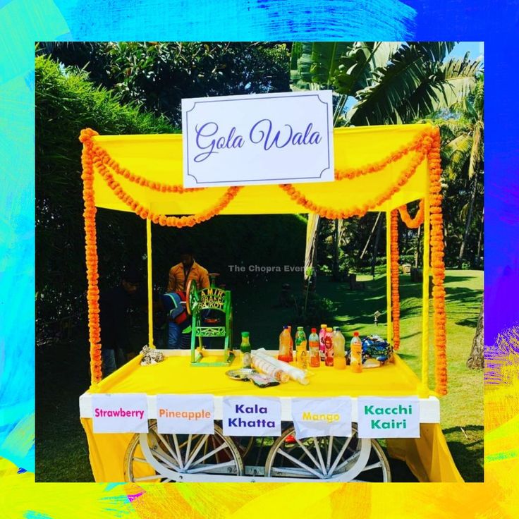 an orange and yellow cart with drinks on it