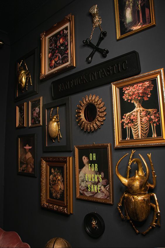 there are many framed pictures on the wall with gold accents and artwork above them, along with other decorative items