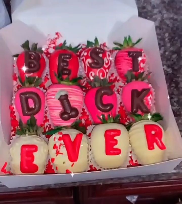 a box filled with lots of cake covered in frosting and strawberries on top of each other