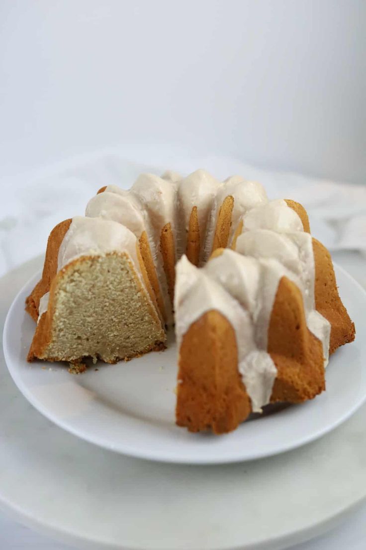 a bundt cake with white icing on a plate