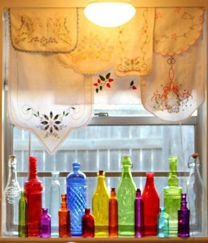 colorful bottles are lined up in front of the window