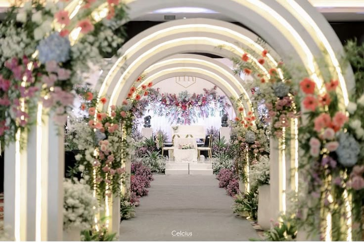 an archway decorated with flowers and greenery