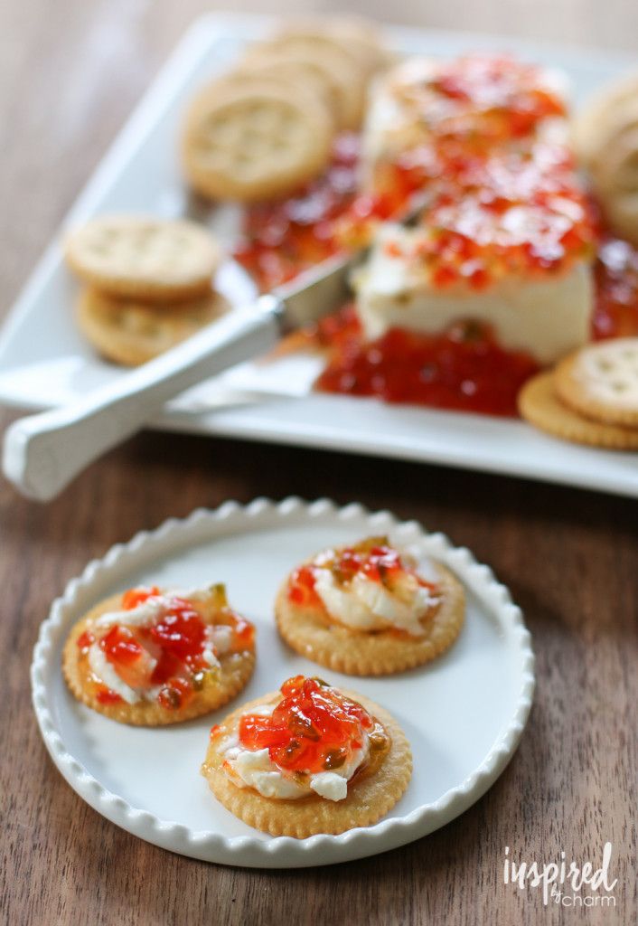 small appetizers are sitting on a plate next to a platter of crackers