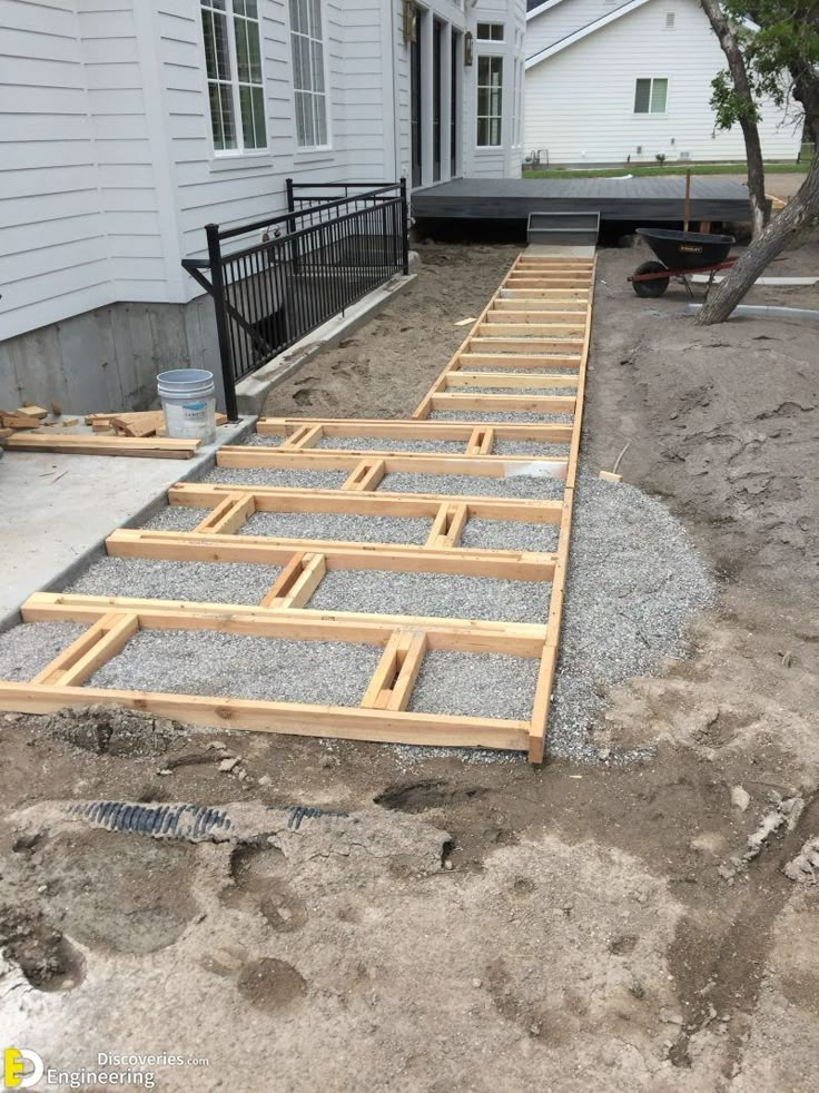 a house being built with wood and gravel