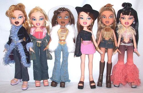 five dolls are lined up in different outfits