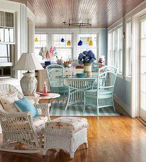 a living room filled with lots of furniture and decor on top of a hard wood floor