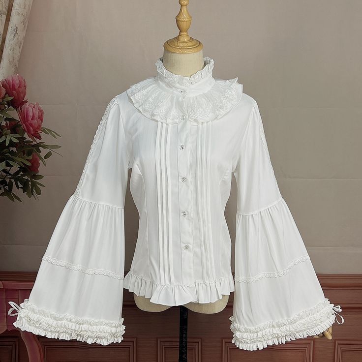 This price is for a shirt only, others are not included. Collar:Ruff CollarDress / Top Details:Front Button Placket / Lace Trim / Pleating Details / Ruffle TrimMaterial:Cotton / PolyesterSleeves:Balloon Sleeves / Bell Sleeves / Tie Closures Cuffs Size S M L XL 2XL Shoulders 35 36 37.5 39 40.5 Bust 84 88 92 96 100 Waist 70 74 78 82 86 Sleeve Length 59 60 61 62 63 ... White Collared Shirt With Ruffles, Fitted White Shirt With Ruffled Collar, White Fitted Shirt With Ruffled Collar, Fitted White Shirt With Ruffles, White Ruffled Collared Shirt, White Classic Top With Ruffled Collar, Classic White Top With Ruffled Collar, White Cotton Shirt With Ruffled Collar, Classic Long Sleeve Shirt With Ruffles