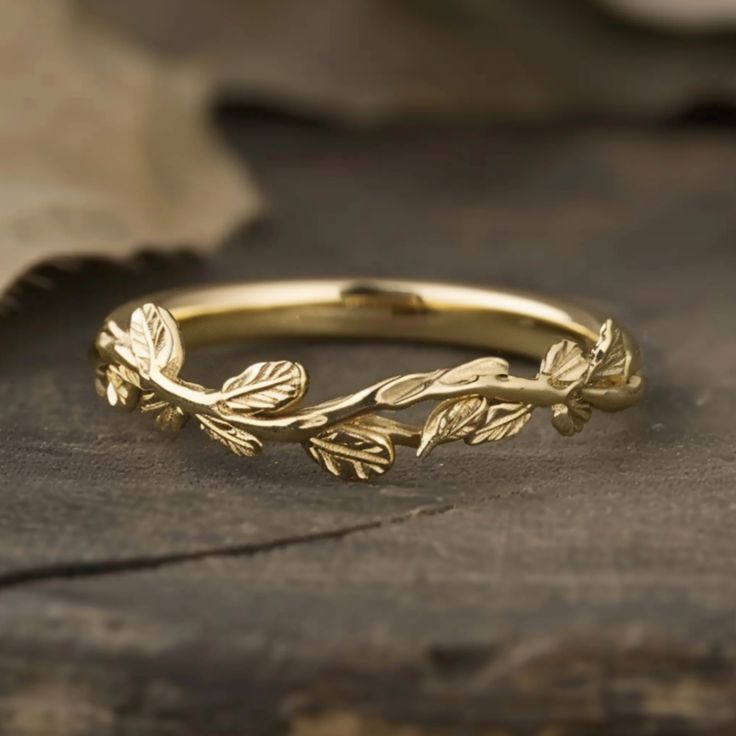 a gold ring with leaves on it