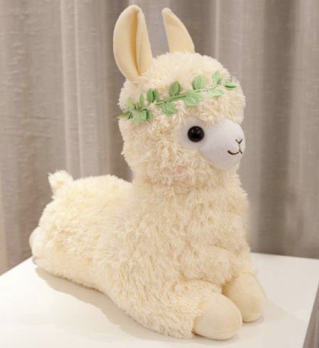 a stuffed llama sitting on top of a table