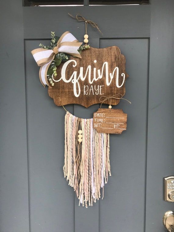 a wooden sign hanging on the side of a gray door that says gavin'kash