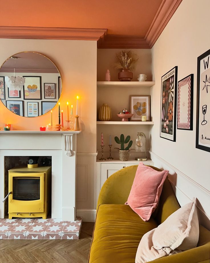 a living room filled with furniture and a fire place in the middle of it's wall