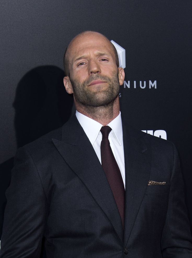 a bald man wearing a suit and tie