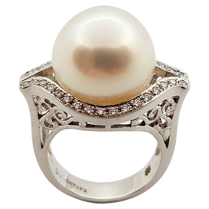 Pearl with Diamond 0.30 carat Ring set in 18 Karat White Gold Settings Width: 2.4 cm Length: 1.6 cm Ring Size: 53 Total Weight: 14.0 grams Pearl: 14.4 mm "We first opened doors in 1980 when it was then situated in the vicinity of the Victory Monument; a small and modest storefront with a couple of counters. From its humble beginnings to where it stands today, our company has proven its abilities as a jeweler. Since the beginning, we have been supplying fine quality pieces to dealers, wholesalers Diamond Ring Set, Tahitian Black Pearls, Pearl And Diamond Ring, White Gold Set, Diamond Ring Settings, Pearl Diamond, White Gold Ring, Round Brilliant Cut Diamond, Pearl Ring