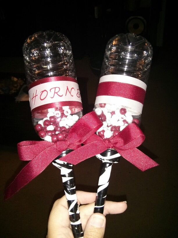 two candy lollipops are wrapped in red and white ribbon, with the words horns on them