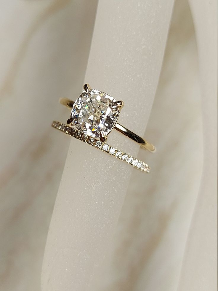 an engagement ring with a cushion cut diamond