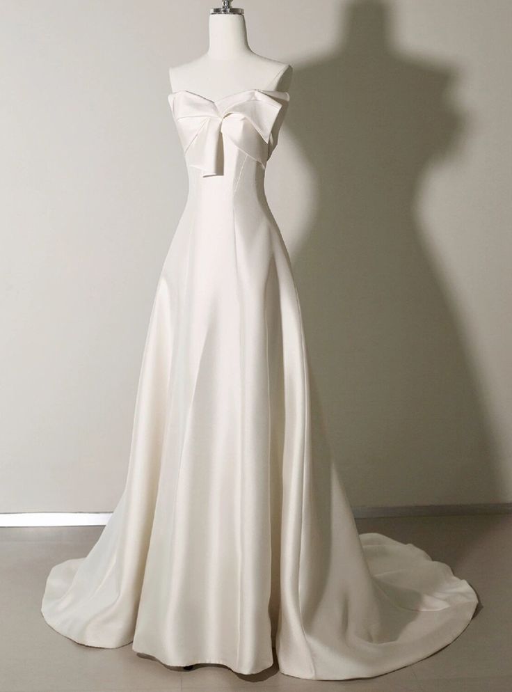 a white wedding dress on a mannequin