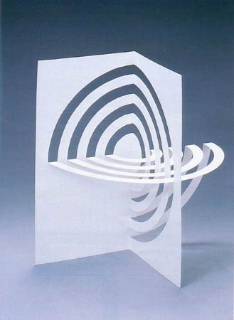 an abstract white sculpture with spirals and lines on the front, against a blue background