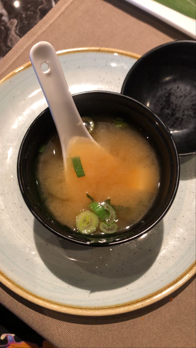 a bowl of soup with a spoon in it