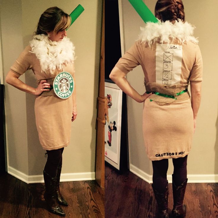 a woman in a dress and boots standing next to a wall with a starbucks sign on it