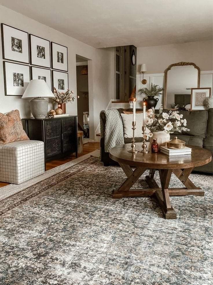 a living room filled with furniture and pictures on the wall