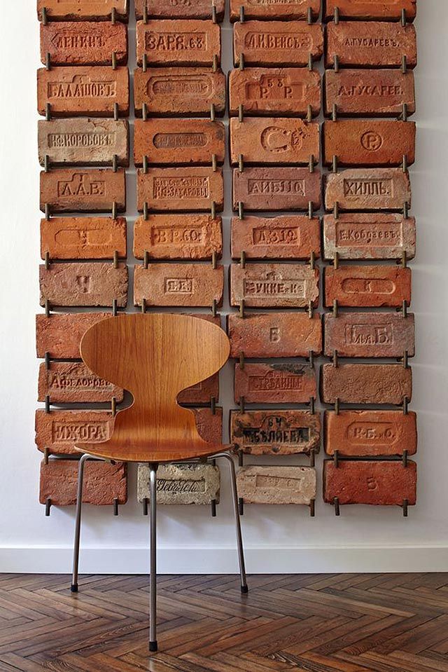 a wooden chair sitting in front of a stack of boxes with words on the wall