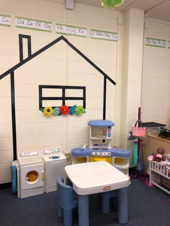 a child's play room with toys and furniture