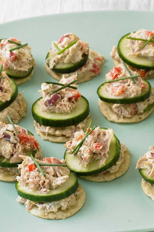 cucumber and crab salad on crackers with toothpicks in the middle