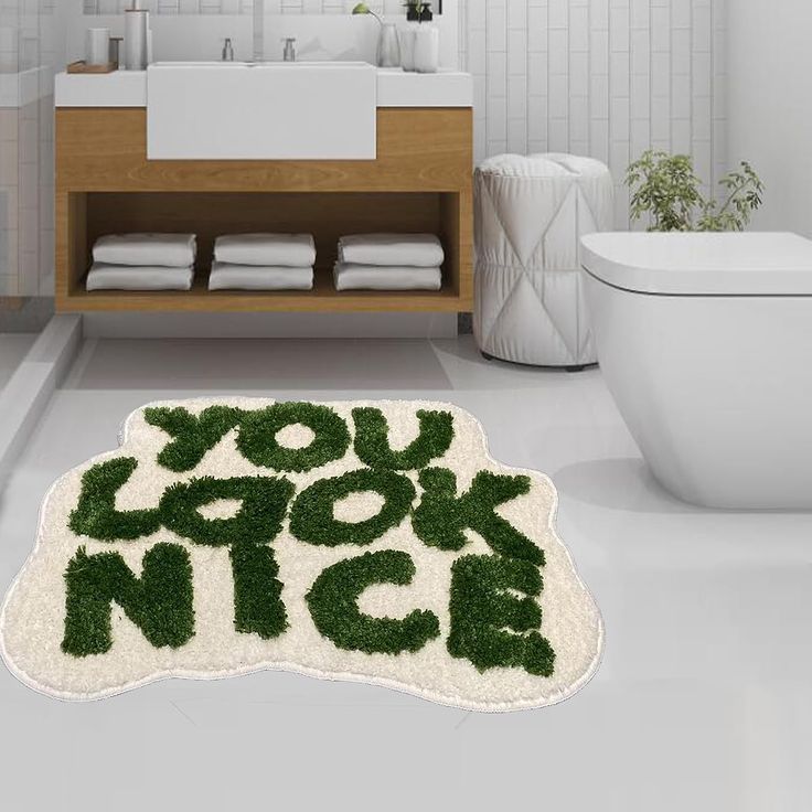 a bathroom with a rug that says you look nice