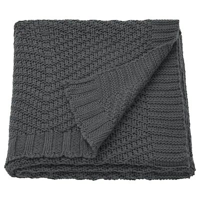 a gray knitted blanket folded on top of each other