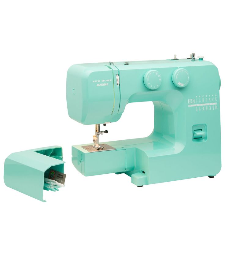 the sewing machine is green and has two attachments for it to be used on