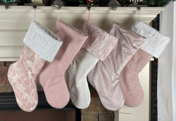 three stockings hanging from a mantel over a fireplace