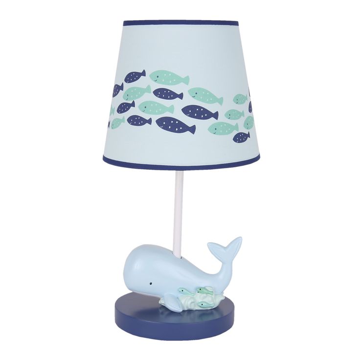 a lamp with a blue base and a white whale on it's body is shown