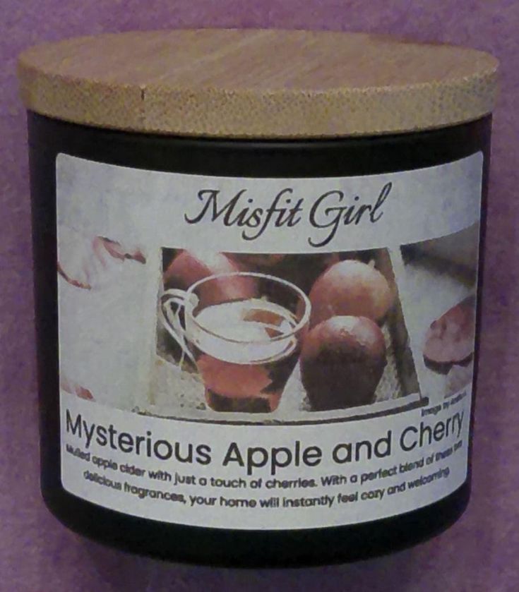 a jar of apple and cherries on a purple background with the label in english