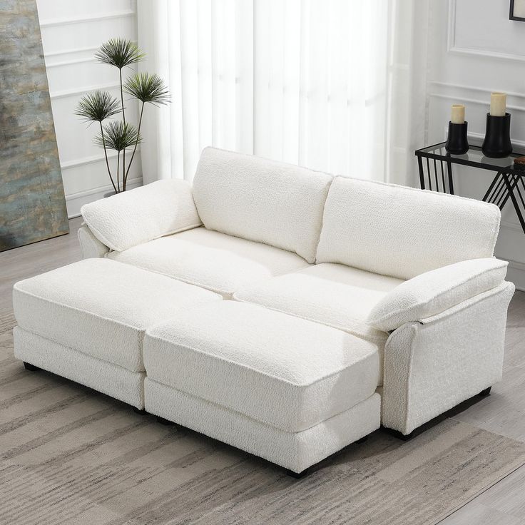 a white couch sitting on top of a hard wood floor