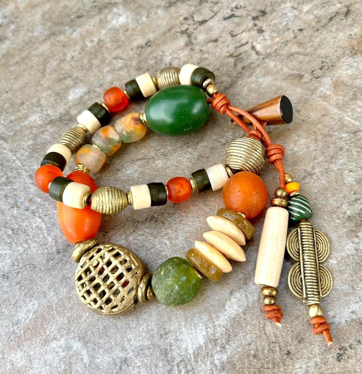 Bohemian Bracelet African Tribal Copal,  Glass, Bone and Lost Wax Brass Beads Artisan Beaded Wrap Bracelet With Round Beads, Artisan Wrap Bracelet With Round Beads For Festivals, Artisan Beaded Wrap Bracelet, Bohemian Orange Beaded Bangle Bracelets, Bohemian Green Wrap Bracelet With Round Beads, Green Bohemian Wrap Bracelet With Round Beads, Festival Artisan Wrap Bracelet With Colorful Beads, Bohemian Orange Beaded Bangle Bracelet, Earthy Handmade Festival Bracelets