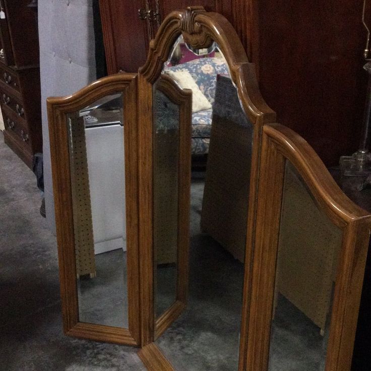 a mirror sitting on top of a wooden dresser