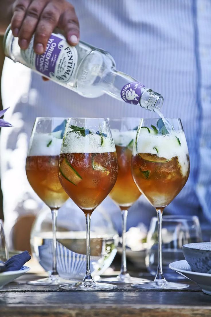 three glasses filled with different types of drinks