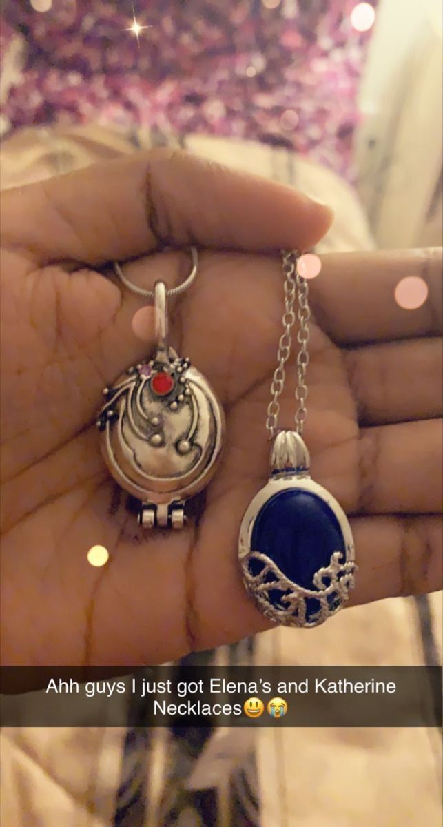 someone is holding two pendants in their hand with the caption, ahh guys i just got ellena's and kateine necklaces