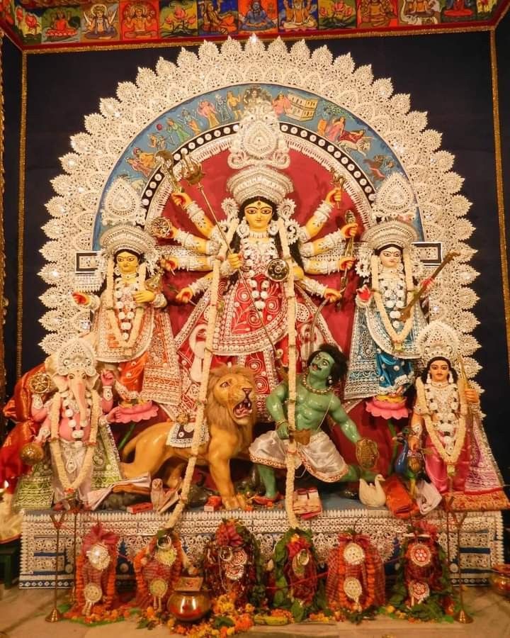 an idol is displayed in front of a colorful backdrop with animals and people around it