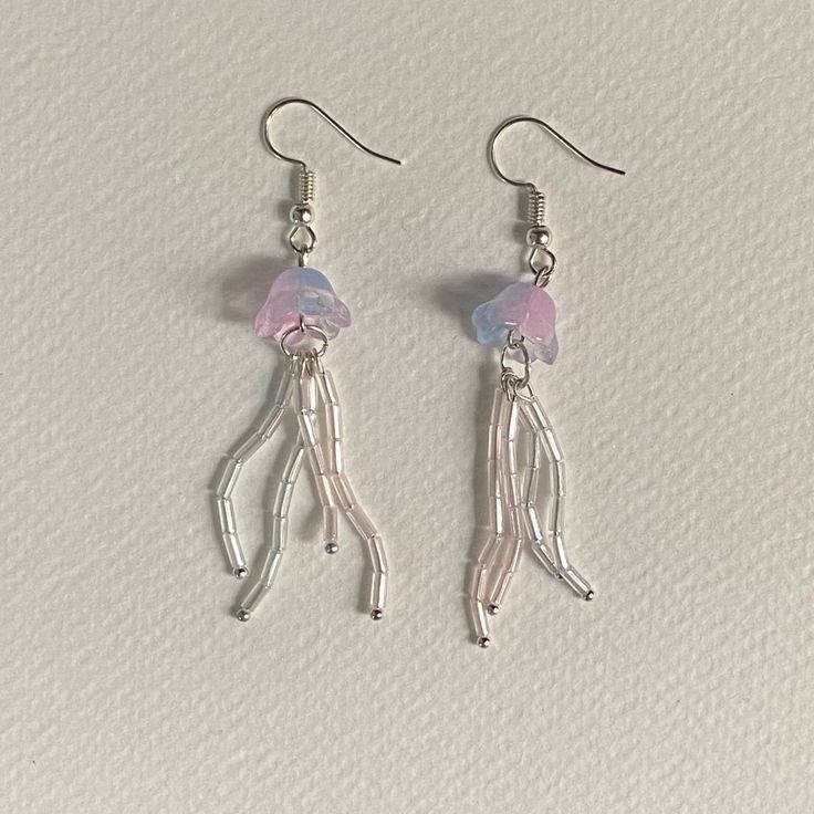 the earrings are made out of silver wire and pink glass beaded with tiny beads