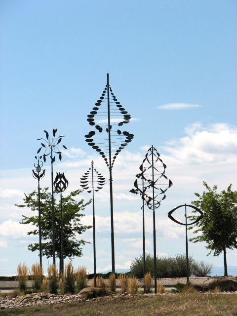 several metal sculptures in the middle of a field