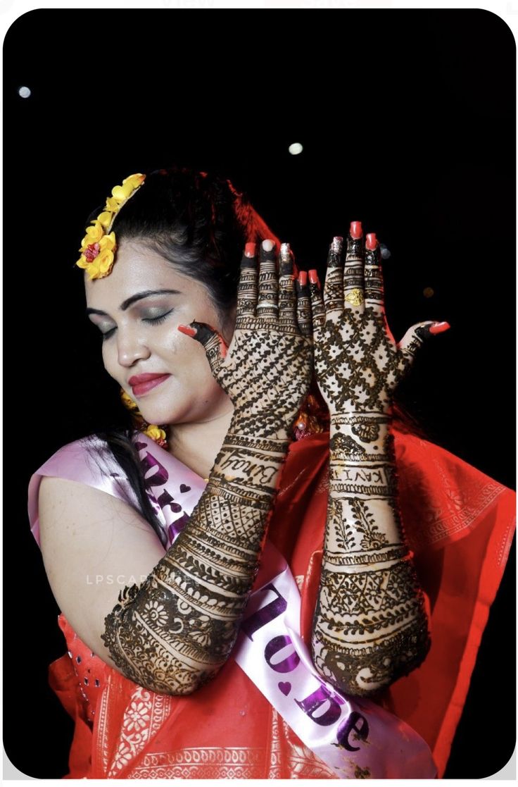 a woman with her hands covered in hennap and makeup is posing for the camera