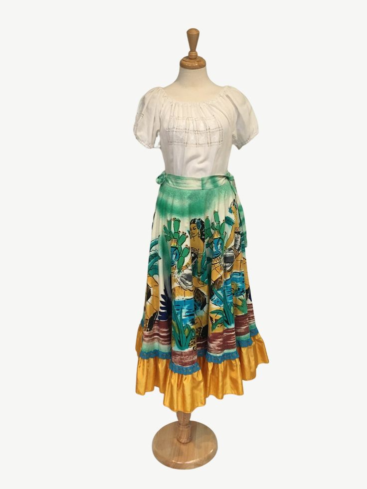 "Authentic 1950s Vintage  Mexican Circle Skirt *This listing is for the skirt only* Beautiful and colorful, this authentic hand painted circle skirt has a Mexican Aztec theme and beach theme. This skirt is so pretty and perfect for a summer barbeque, Cinco de Mayo celebration or just because you feel like being colorful. The skirt is pleated with side zipper closure. SIZE: Small/Med Bust: N/A Waist: 28- 30\" Hip: Flare A-line skirt. Length: 34.5\"(Waist to hem) Please Note:  * Condition: Very Good (This item is vintage and has been worn and loved, I make every effort to post any imperfections, however, some small flaws may go unnoticed.) *The colours in the photos may differ on your computer screen.  *Please read the shop policy for the best customer shopping experience" Traditional Fitted Skirt For Beach, Traditional Beach Fitted Skirt, Traditional Fitted Beach Skirt, Vintage Tiered Skirt For The Beach, Vintage Multicolor Long Skirt, Retro Fitted Skirt For The Beach, Multicolor Relaxed Vintage Skirt, Green Vintage Long Skirt, Vintage Green Long Skirt