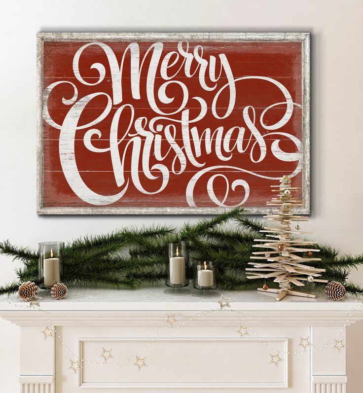 a fireplace mantel with a christmas sign above it