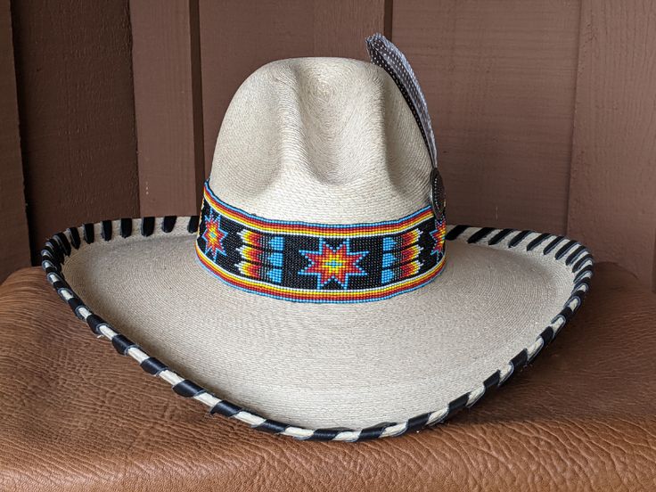 The Santa Fe Chief hat starts with a soft Gus palm hat body that has a 4" brim and 5" crown. Hand laced in 10mm wide black leather lace. The 2" wide beaded hatband has lots of colors in black, blue, red, yellow, orange and white. The back of the band has a deer antler bead for accent. Accented with an Indian Chief Concho and a guinea fowl feather. All hats are made to order. Allow up to 4 weeks for your hat to ship. Adjustable High Crown Felt Hat In Country Style, Traditional Wide Brim Fitted Hat, Traditional Fitted Wide Brim Hat, Southwestern Brimmed Fitted Hat, Southwestern Style Fitted Brimmed Hat, Western Style High Crown Top Hat For Festival, Western High Crown Adjustable Fedora, Traditional Adjustable Panama Hat With Curved Brim, Western High Crown Fedora With Adjustable Fit