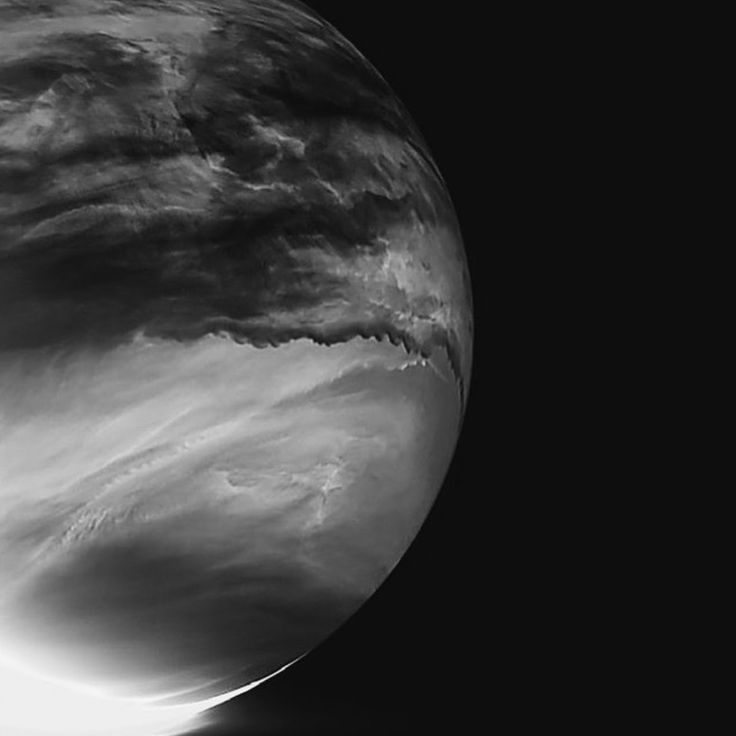 an image of the moon taken from space in black and white, with some clouds