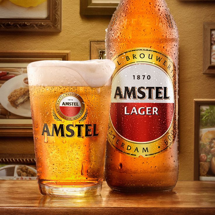 a beer bottle and glass sitting on a table